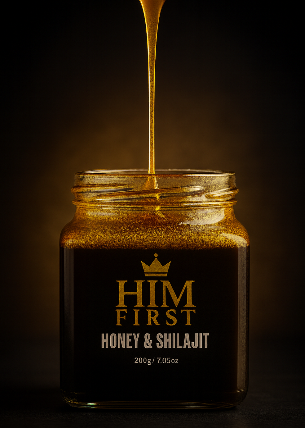 Jar of 'Him First Honey & Shilajit' with honey being poured into it on a dark background.